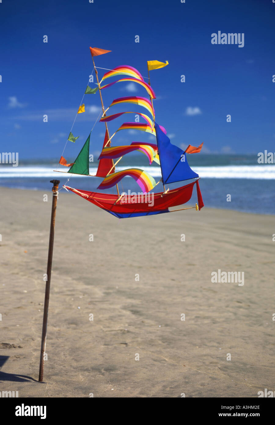 Brightly coloured kite in the shape of a ship for sale on Kuta beach Bali Indonesia Stock Photo