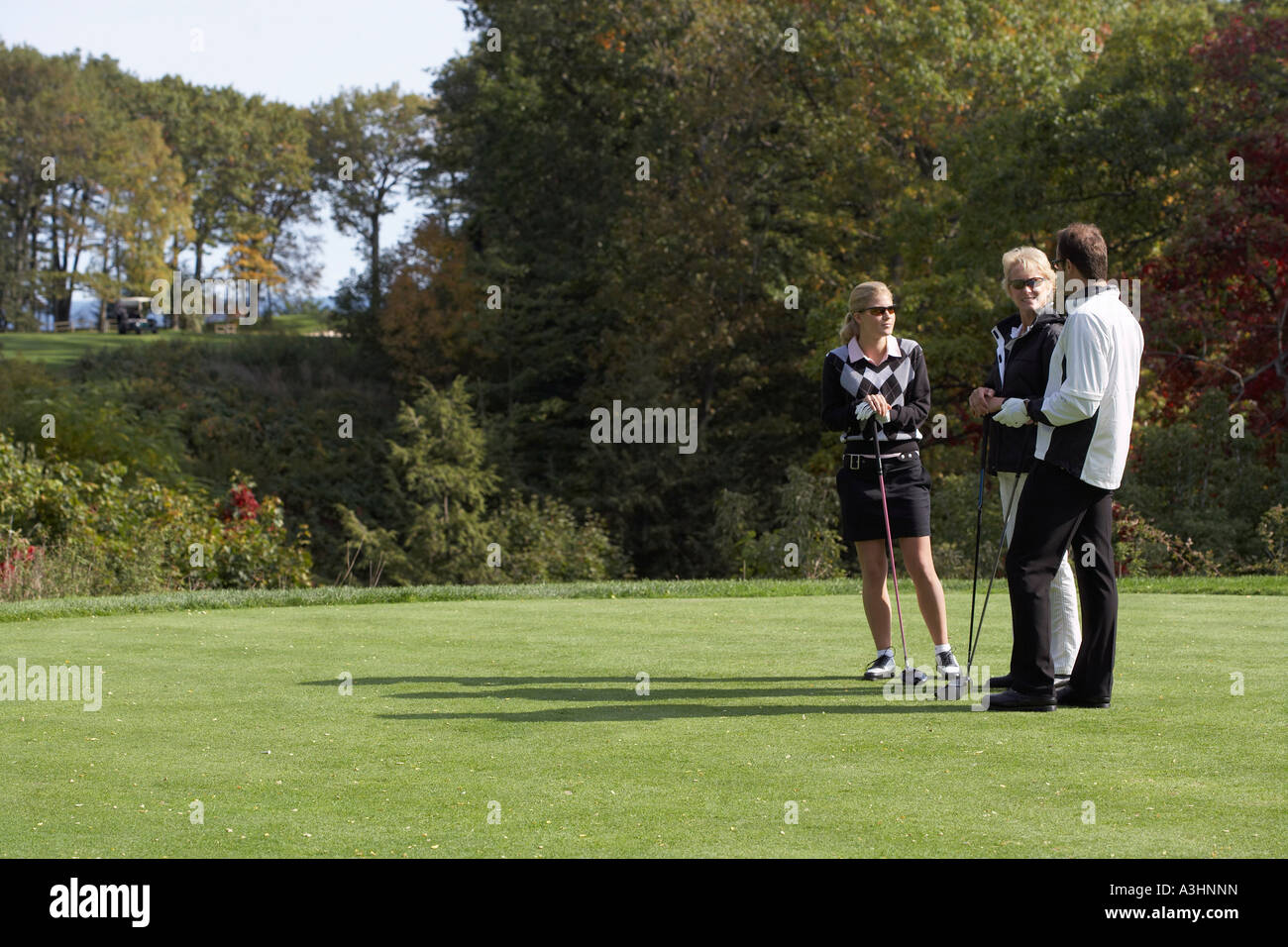 People Standing on Golf Course Stock Photo
