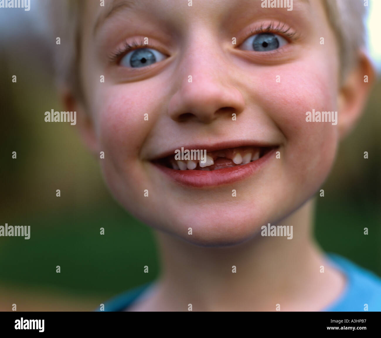 Young boy smiling with tooth missing Stock Photo