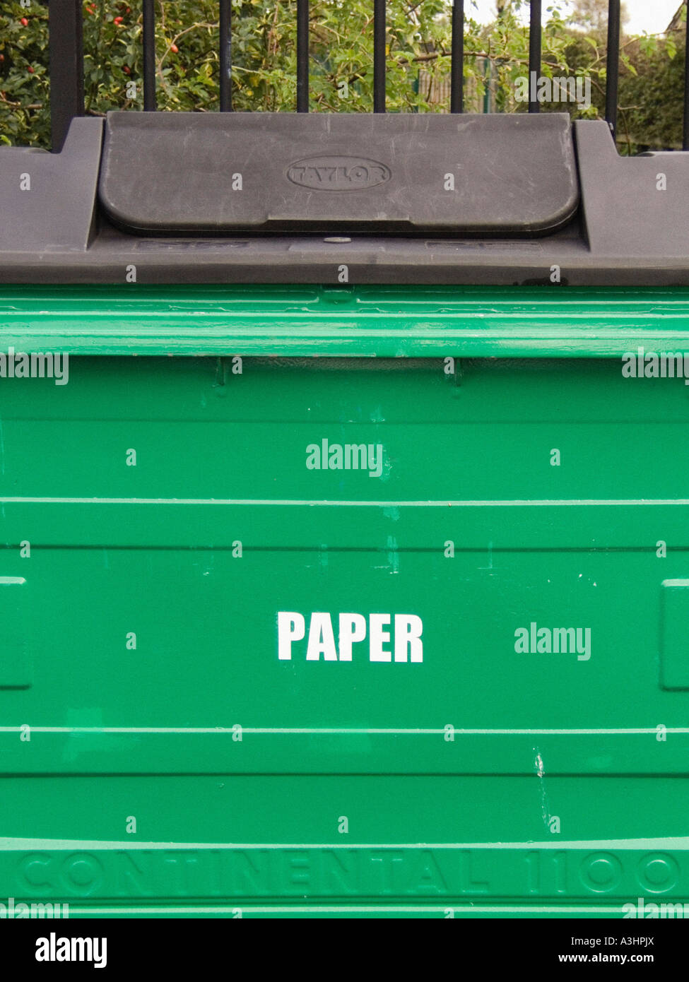 Closeup of an industrial size, green coloured, paper recycling bin