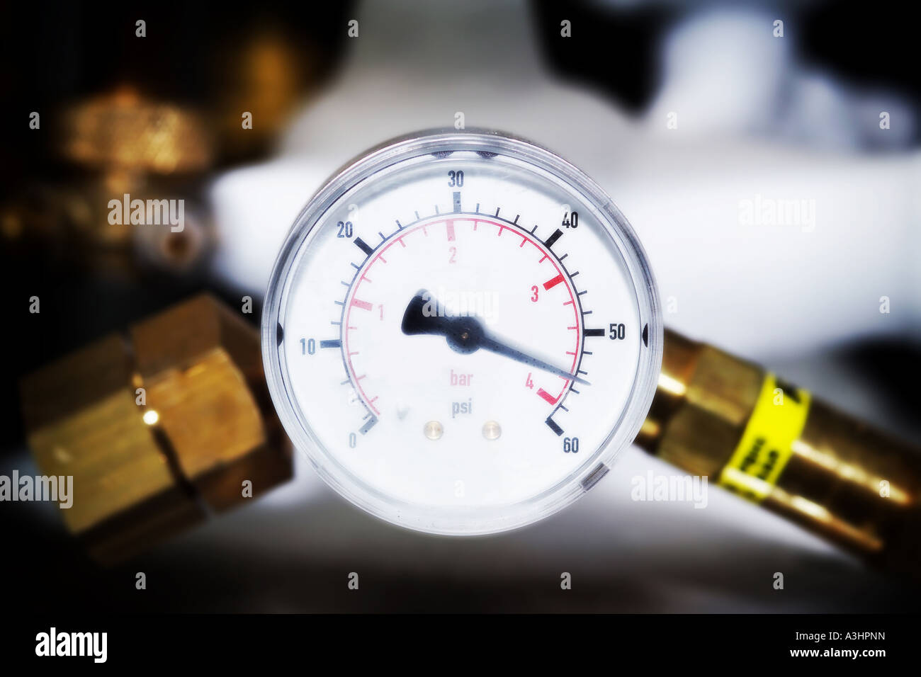 Pressure gauge on scientific equipment in laboratory showing very high