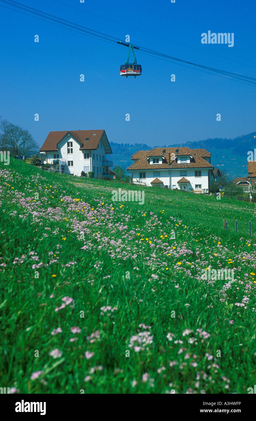 a cable car above houses at Beckenried at Lake Lucerne in Switzerland Stock Photo