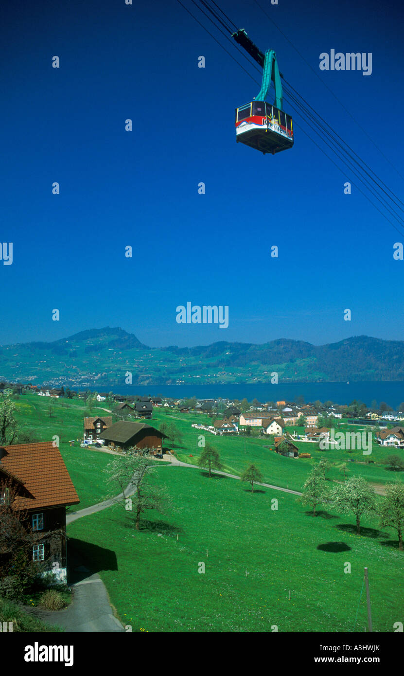 a cable car above houses at Beckenried at Lake Lucerne in Switzerland Stock Photo