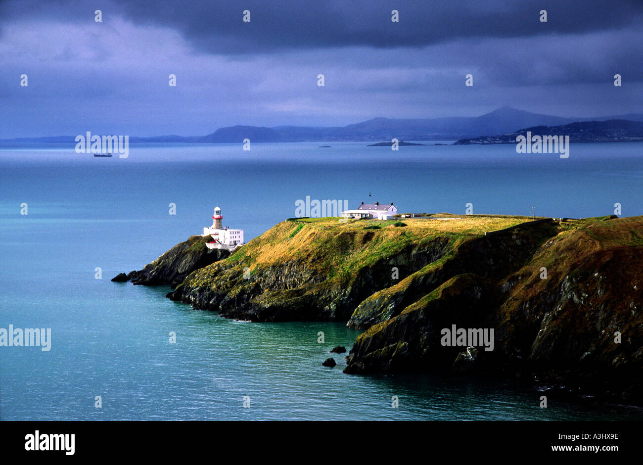 Irish Lighthouse in howth head co Dublin over looking Dublin Bay with moody light Stock Photo