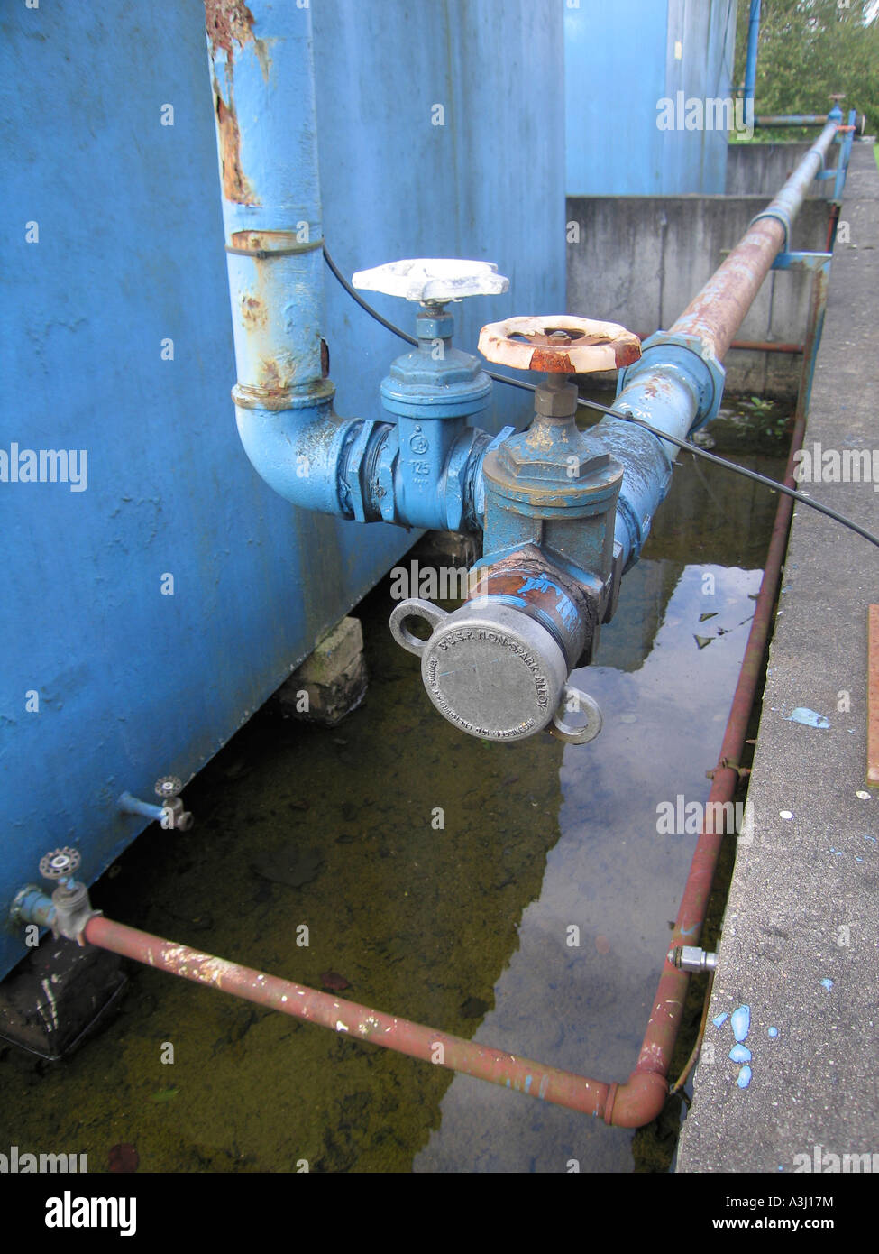 Detail of valve and bund at diesel storage tank Stock Photo Alamy