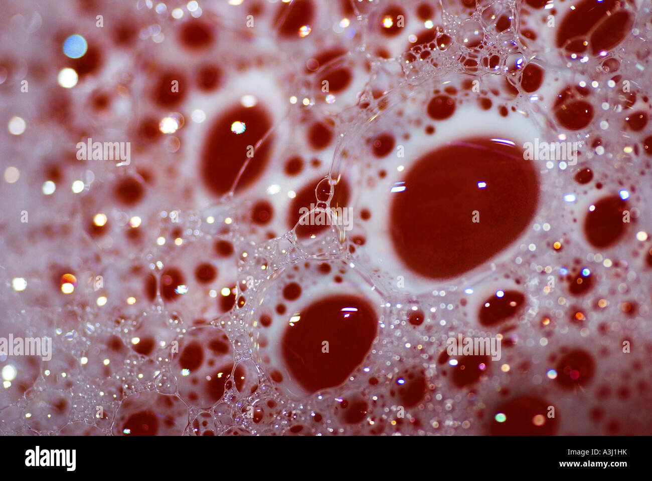 Red bathwater with bubbles Stock Photo
