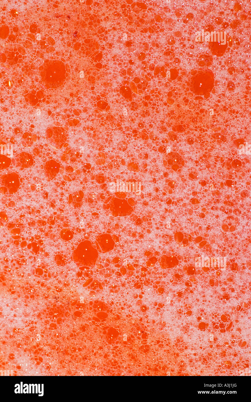 Red bathwater with bubbles Stock Photo