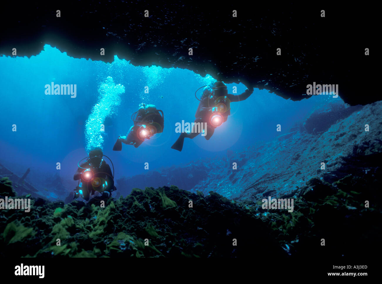 skin divers exploring underwater cave in Florida spring Stock Photo