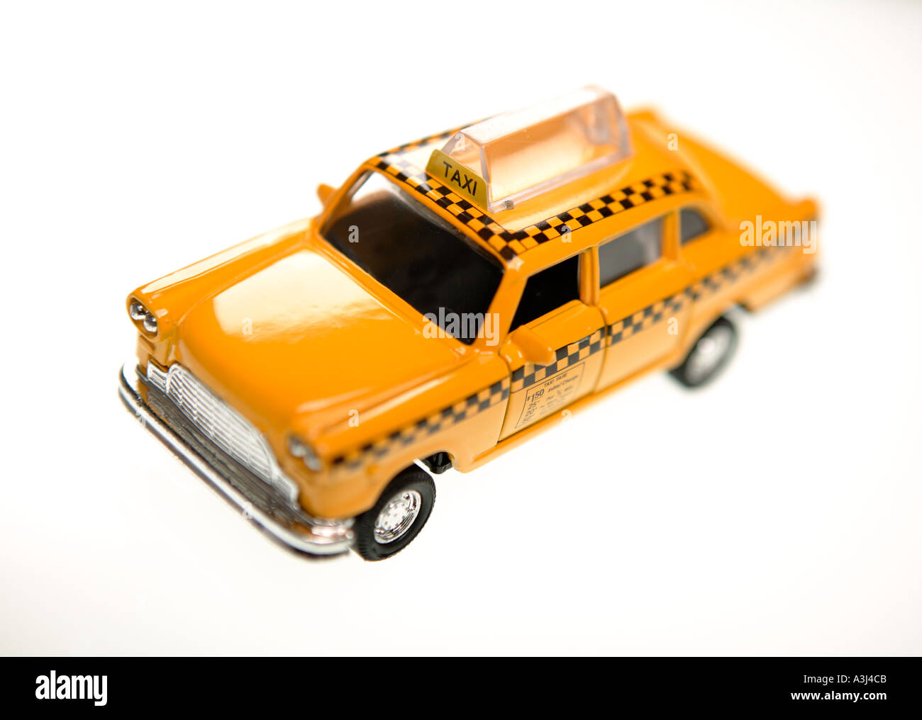 MODEL OF NEW YORK YELLOW TAXI CAB ON WHITE BACKGROUND Stock Photo