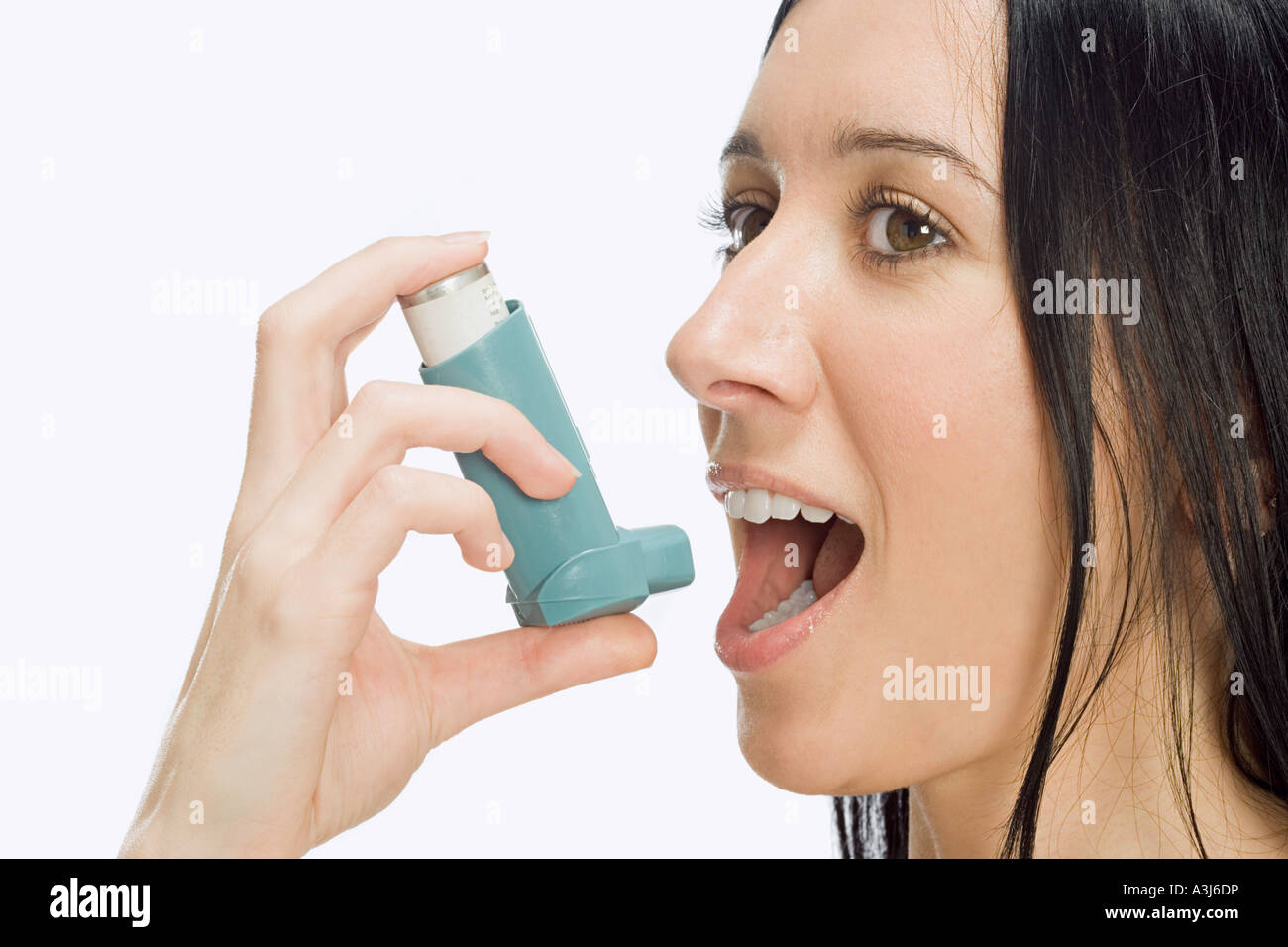 Woman using inhaler Stock Photo - Alamy