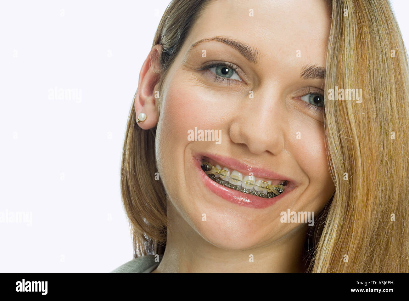 Friendly pleasant good-looking woman in matching outfit holding smartphone  over chest tilting head smiling broadly showing cute gapped teeth being  Stock Photo - Alamy