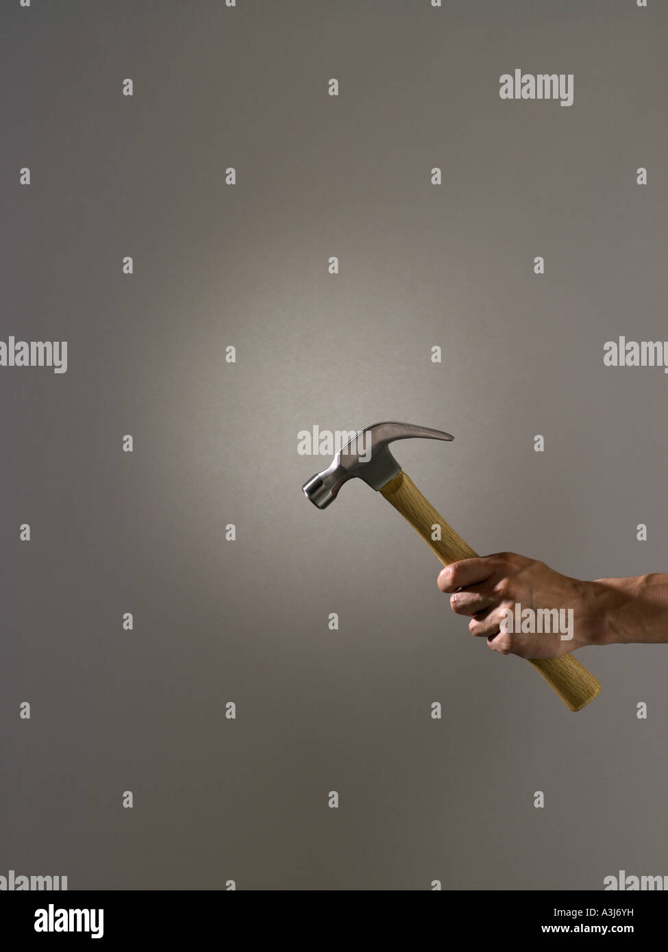 Person holding a hammer Stock Photo - Alamy