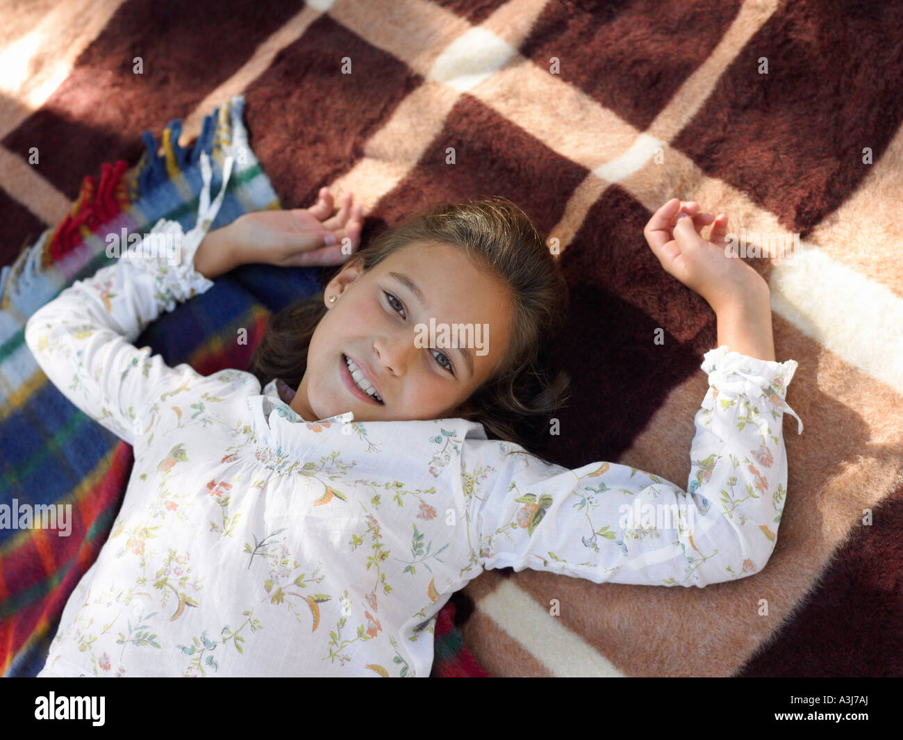 Girl lying on blankets Stock Photo Alamy