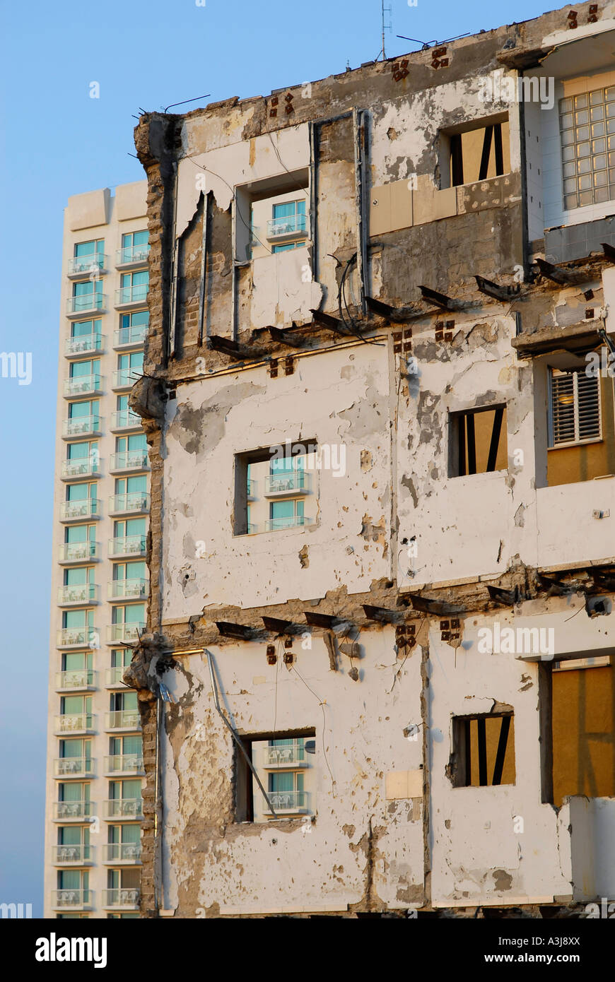 Remnant of demolished building stands in stark contrast to modern hotel