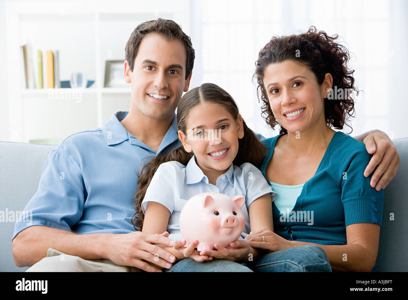 Family with a piggy bank Stock Photo - Alamy