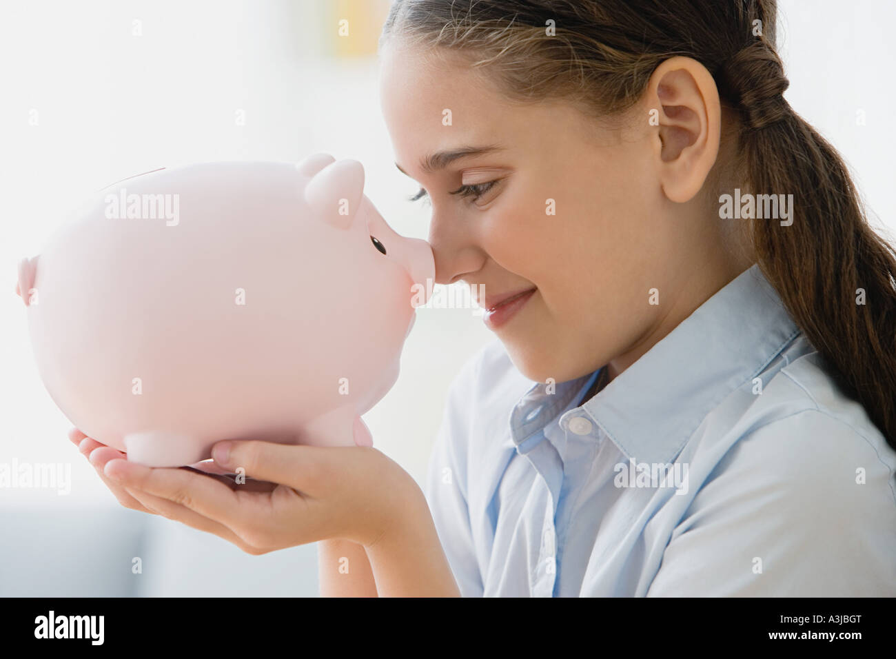 Girl holding a piggy bank Stock Photo - Alamy