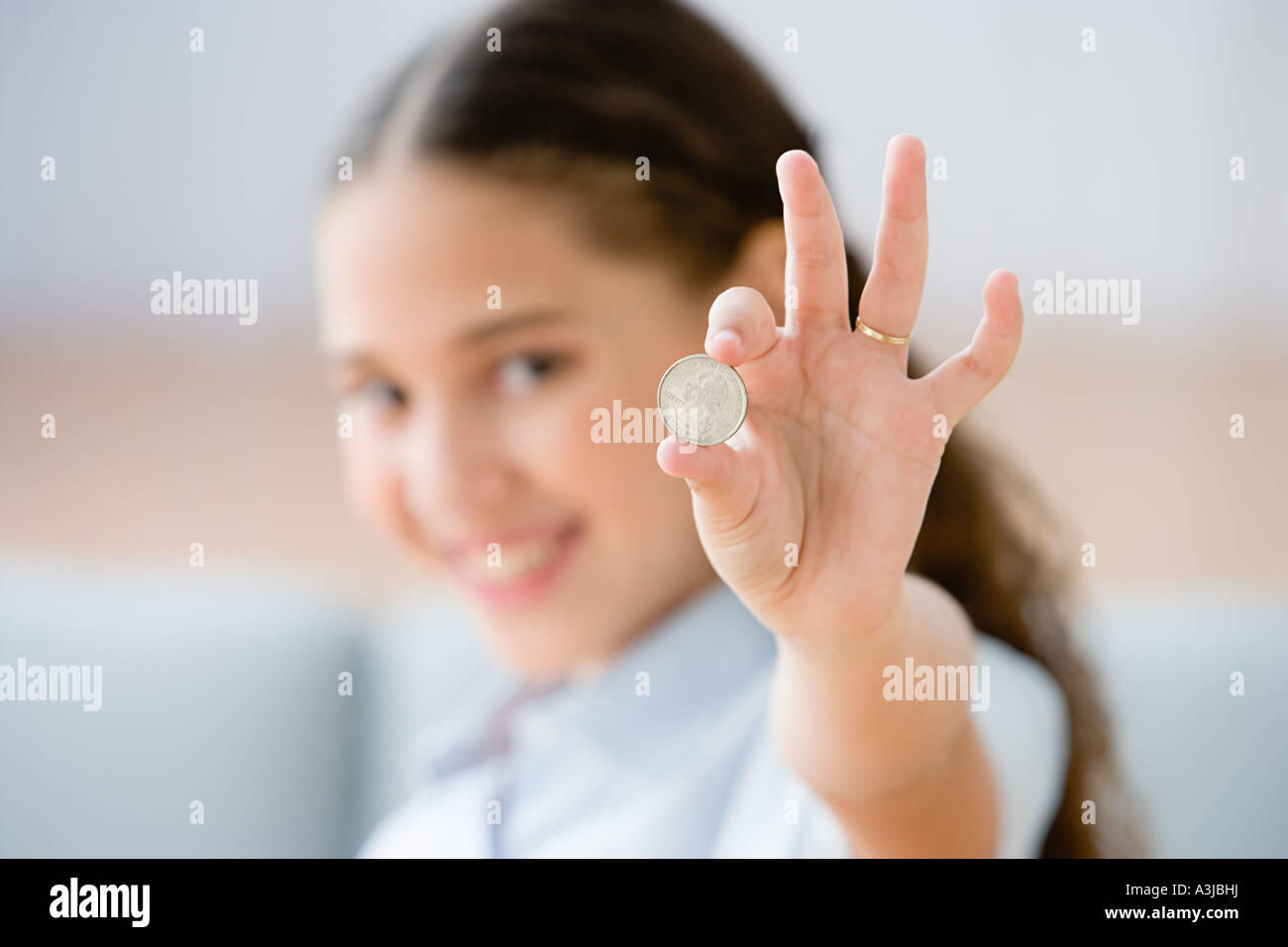 Girl holding a coin Stock Photo Alamy