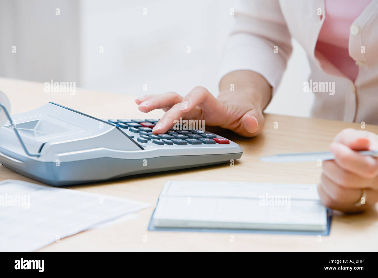 Woman using a calculator Stock Photo - Alamy