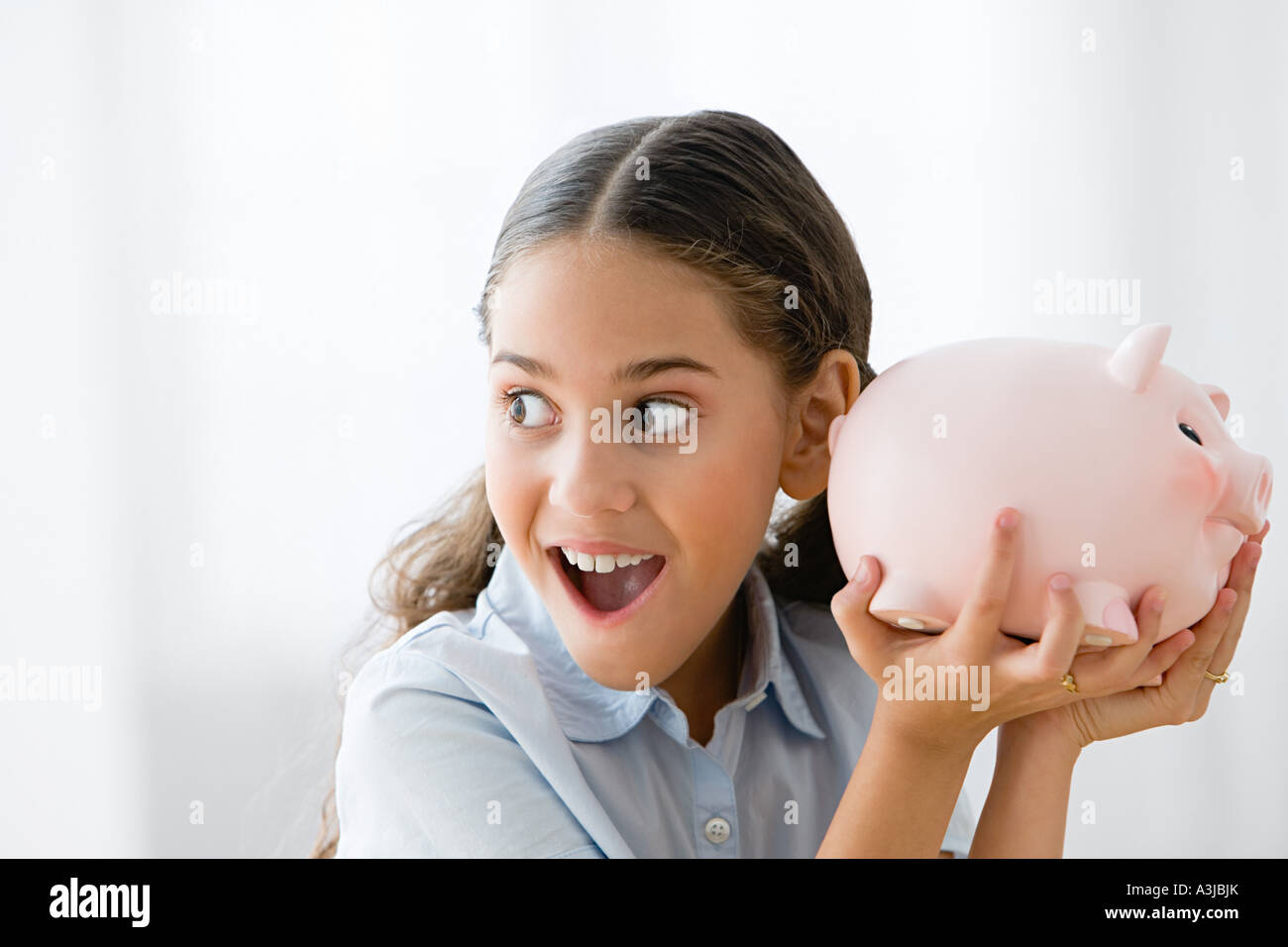 Girl holding a piggy bank Stock Photo - Alamy