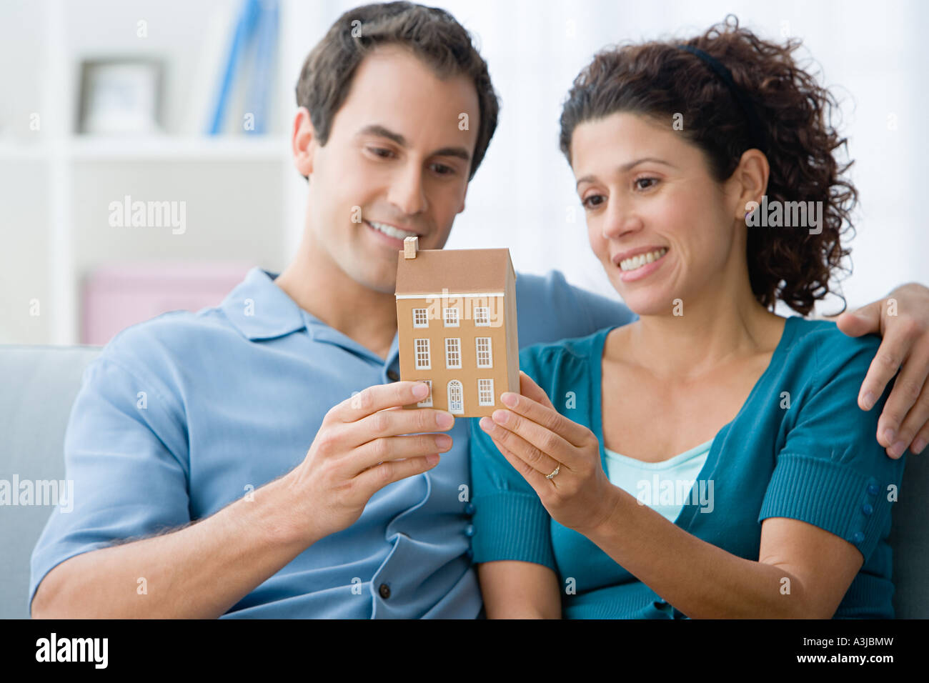 Couple holding a model of a house Stock Photo - Alamy