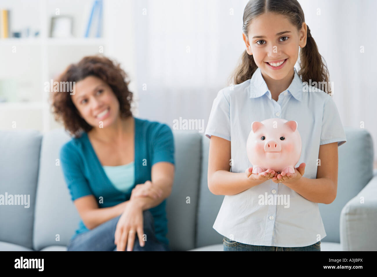 Girl holding a piggy bank Stock Photo - Alamy
