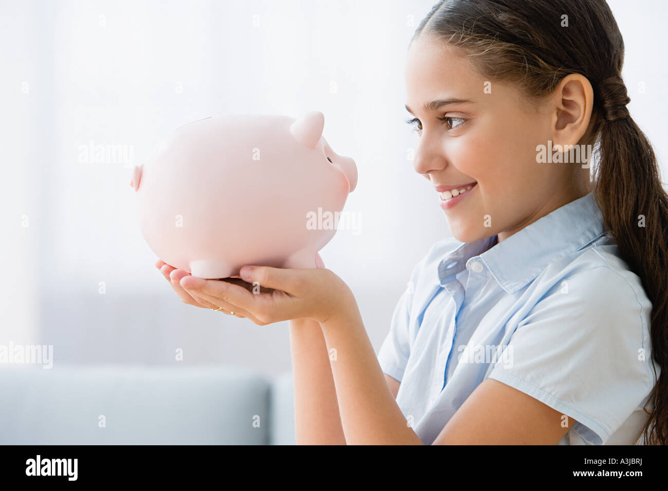 Girl holding a piggy bank Stock Photo - Alamy