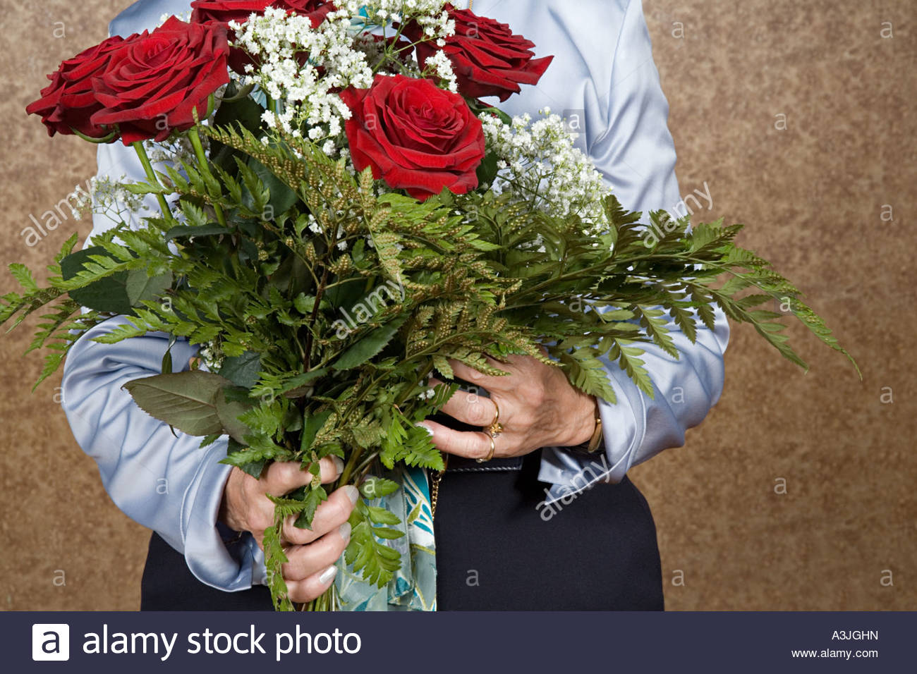 woman holding bouquet of flowers A3JGHN