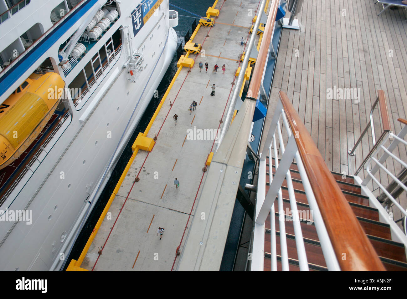 Top deck of a cruiseship looking downwards on tiny people at pier of Costa Maya Mexico Stock Photo