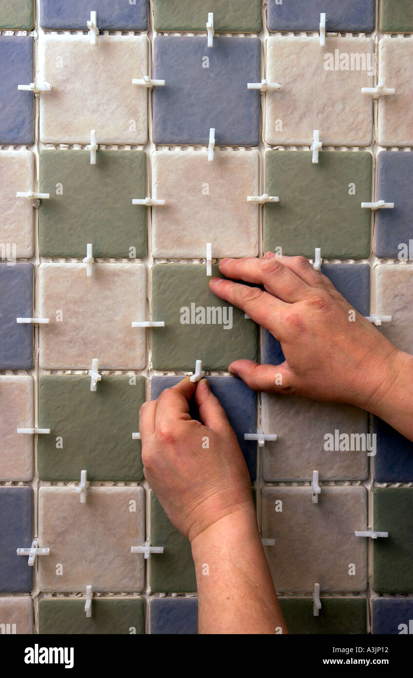 TILING A BATHROOM WITH PILKINGTON TILES AND TILE SPACERS Stock Photo