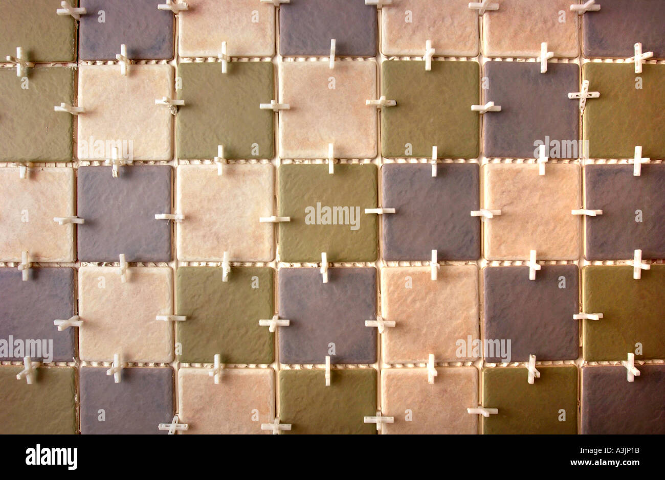 TILING A BATHROOM WITH PILKINGTON TILES AND TILE SPACERS Stock Photo