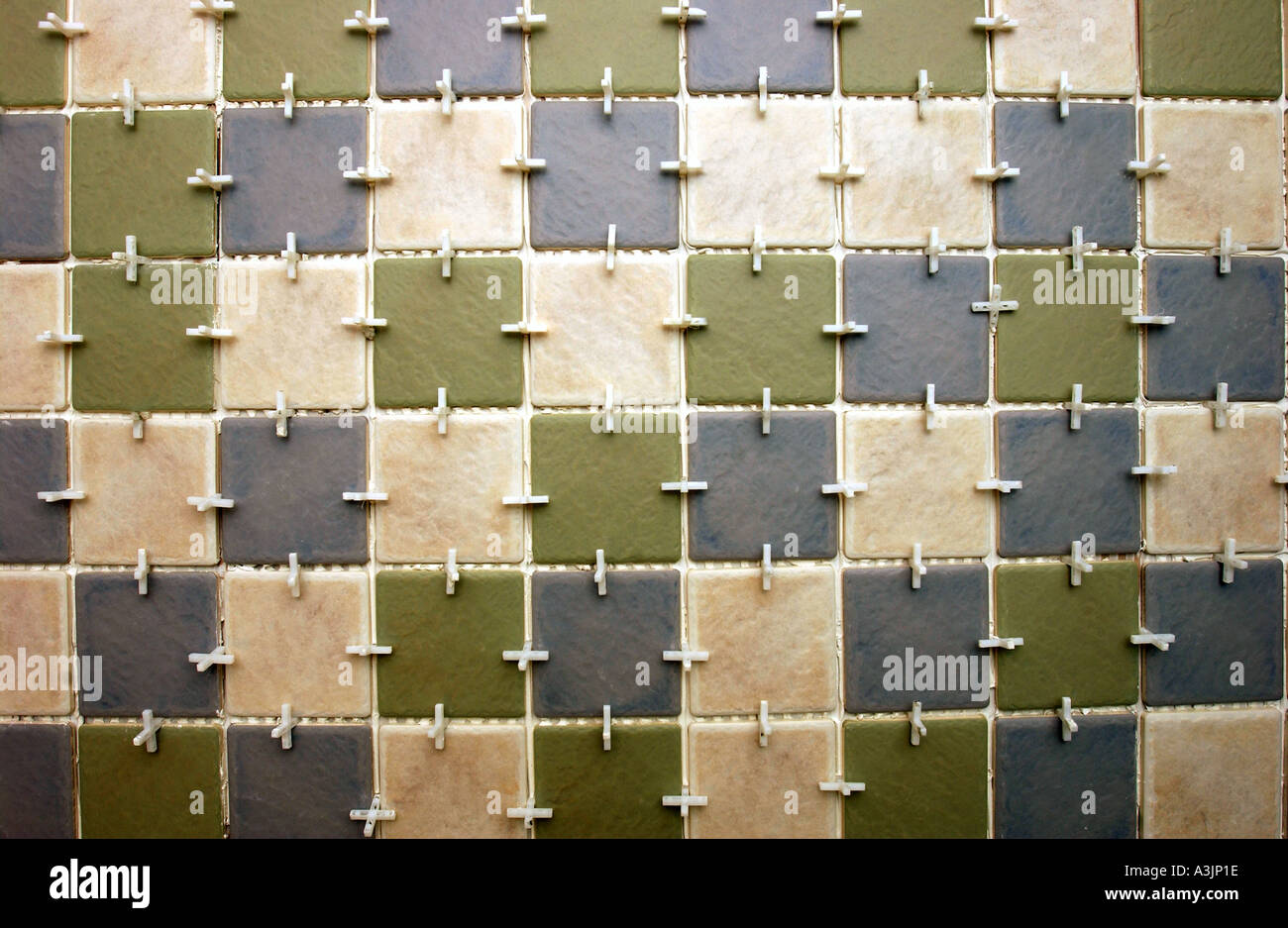 TILING A BATHROOM WITH PILKINGTON TILES AND TILE SPACERS Stock Photo