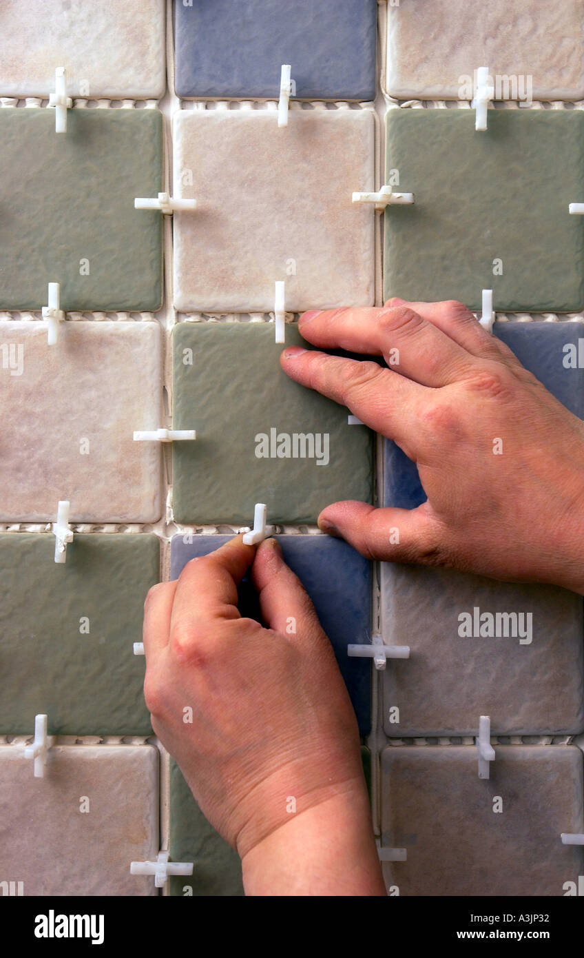 TILING A BATHROOM WITH PILKINGTON TILES AND TILE SPACERS Stock Photo