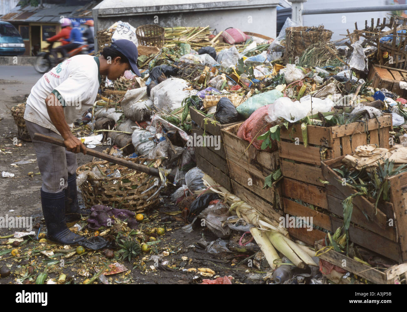 Local man sifting through the garbage by the river in the slum area of Kalipokor Surabaya East Java Stock Photo