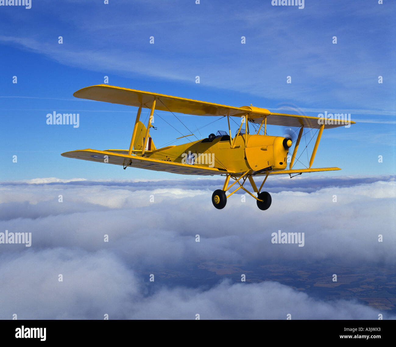 de Havilland Tiger Moth above clouds Stock Photo