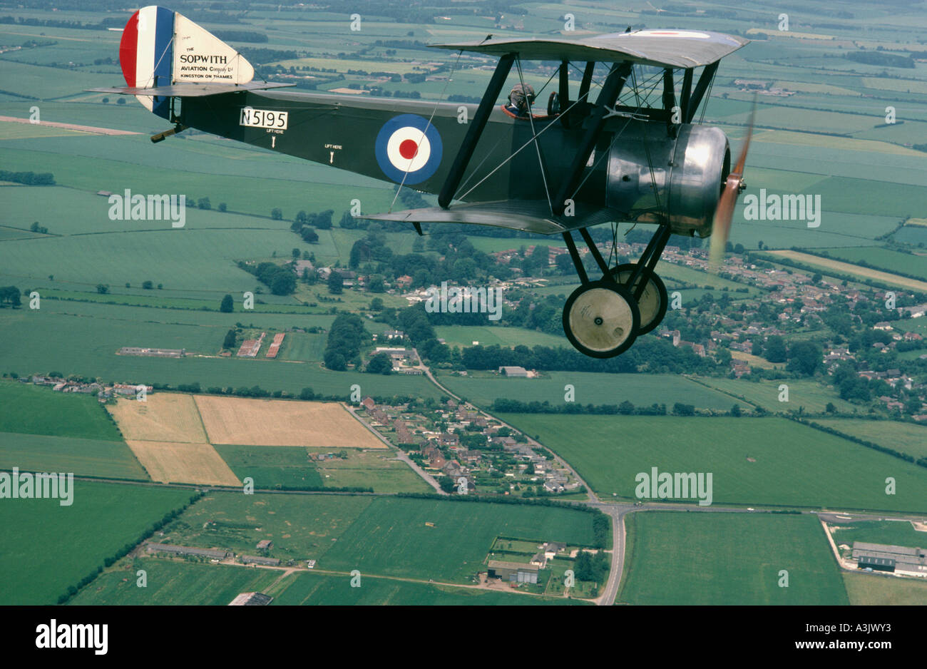 Sopwith Pup in flight above fields Stock Photo