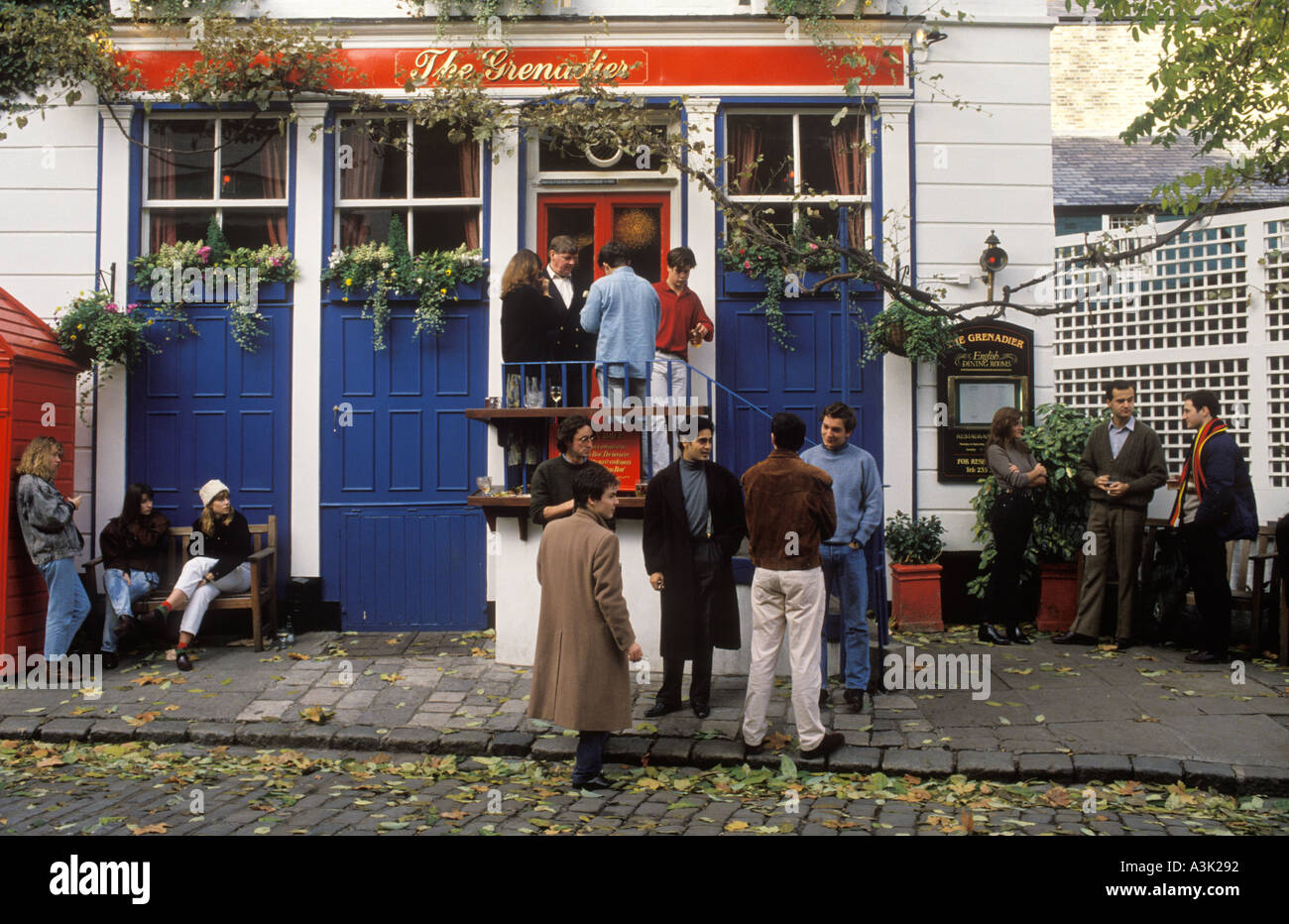 The Grenadier a London pub, group people outside of the front of building. Near Hyde Park, Wilton Row, Wilton Mews, Belgravia, London England. 1990s Stock Photo