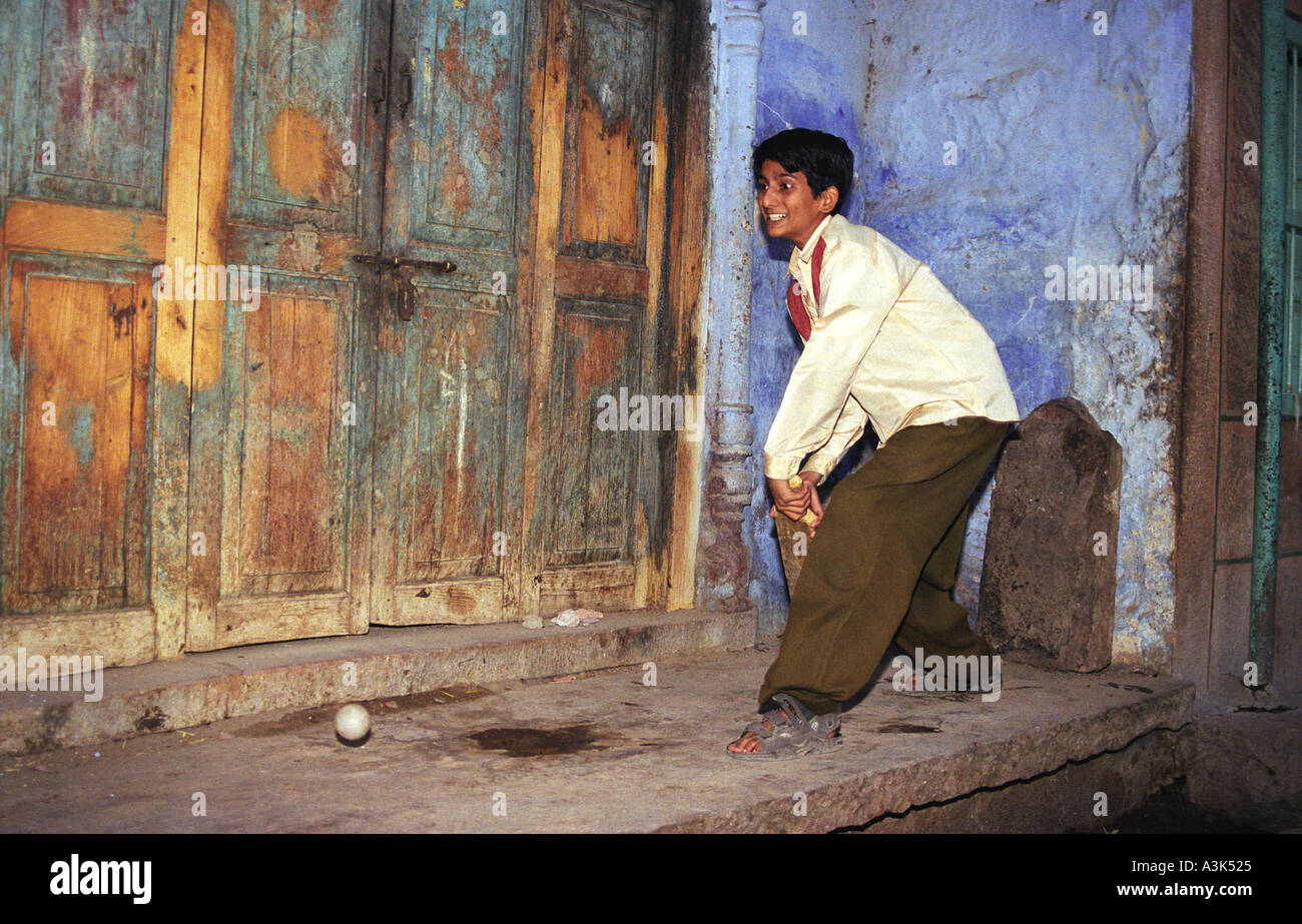 Indian Boy Playing Cricket in the Streets of Jodhpur (India) Stock Photo