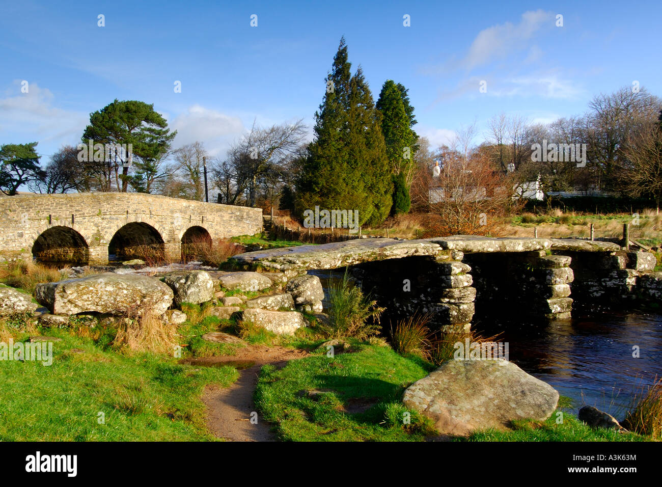 Village of Postbridge Dartmoor showing both the newer stone road bridge crossing and the ancient 14th century clapper bridge Stock Photo