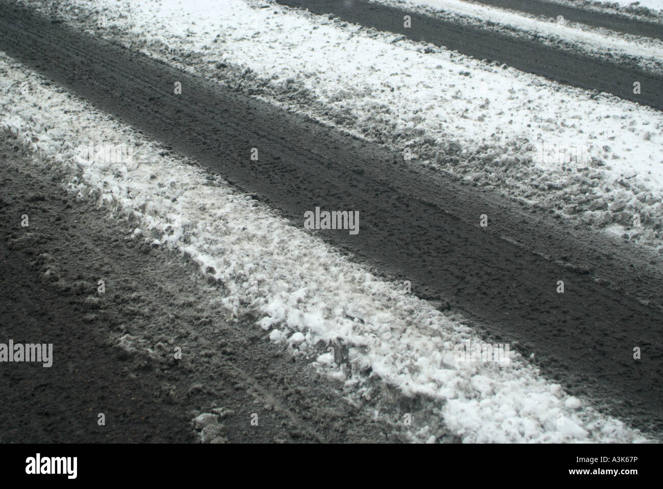 Tracks in the snow as vehicles drive in difficult driving conditions