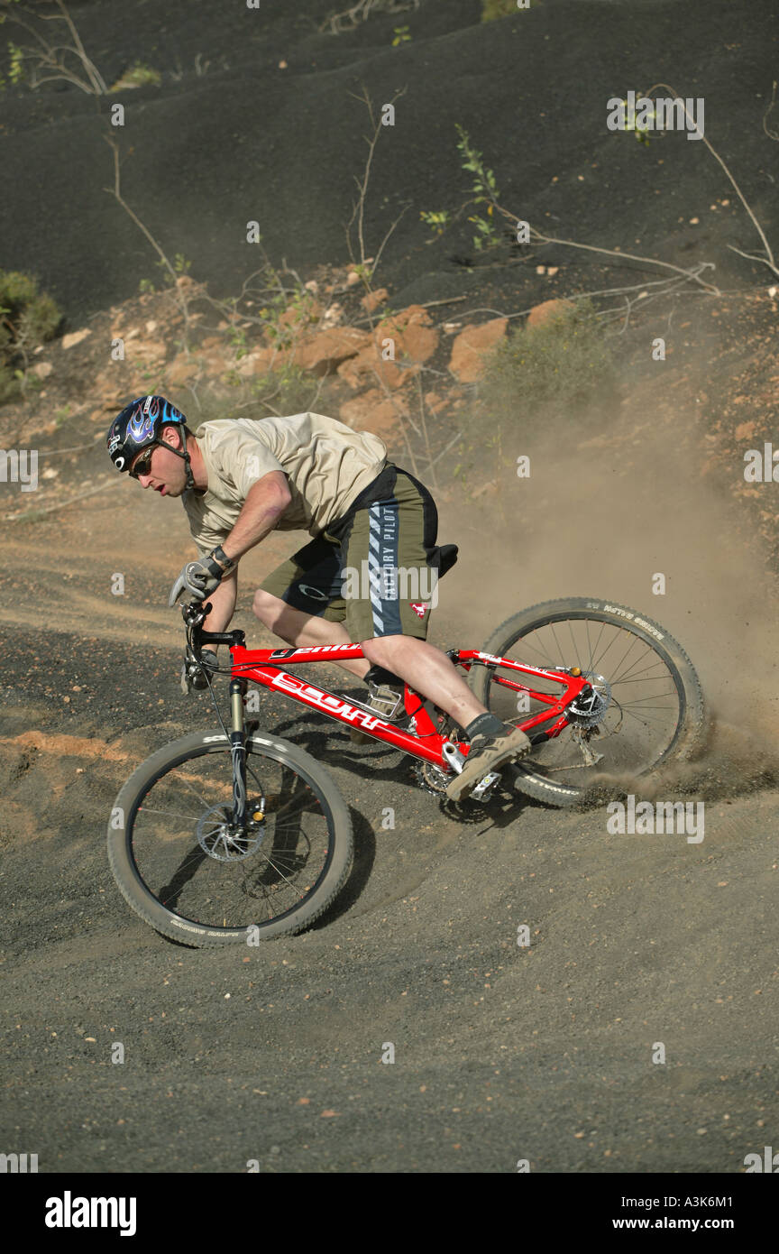 A Mountain Biker riding in a Rugged Landscape Stock Photo