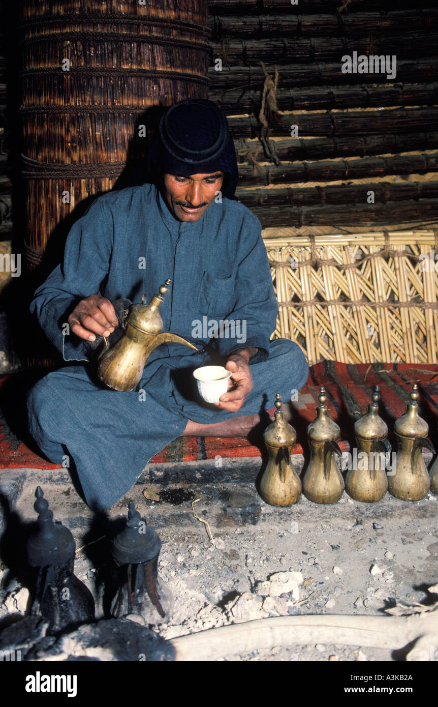 Marsh Arab man Iraq, in reed house with a line of coffee pots. 1984. Southern Iraq Near Basra 1980s HOMER SYKES Stock Photo
