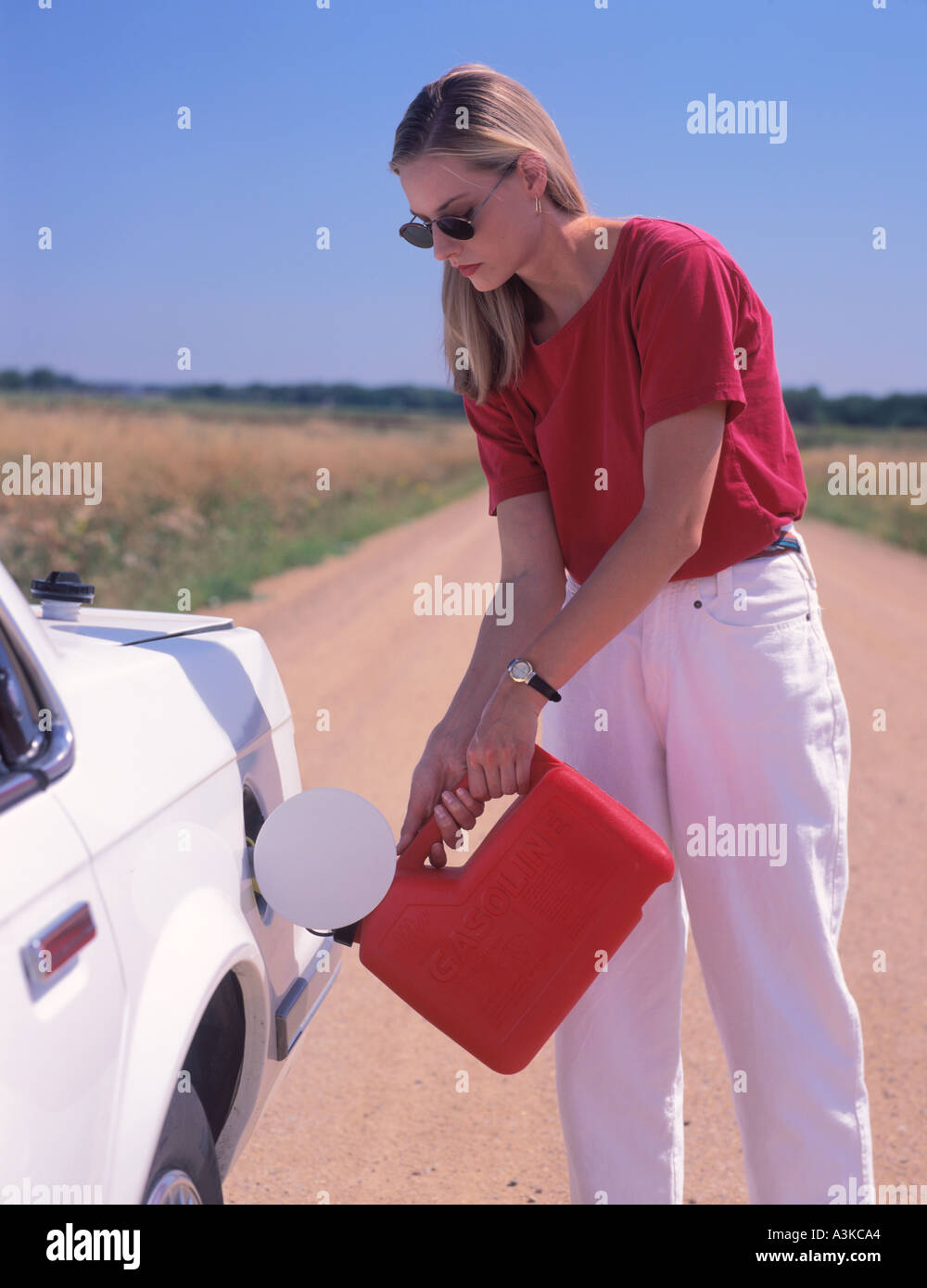 a woman with her out of gas car Stock Photo - Alamy