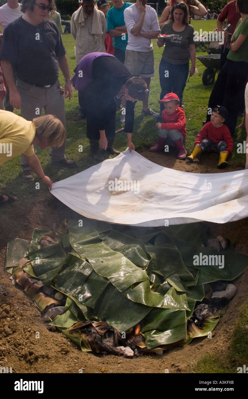 Covering the pit oven at a curanto, cooking in a pit oven, vegetables