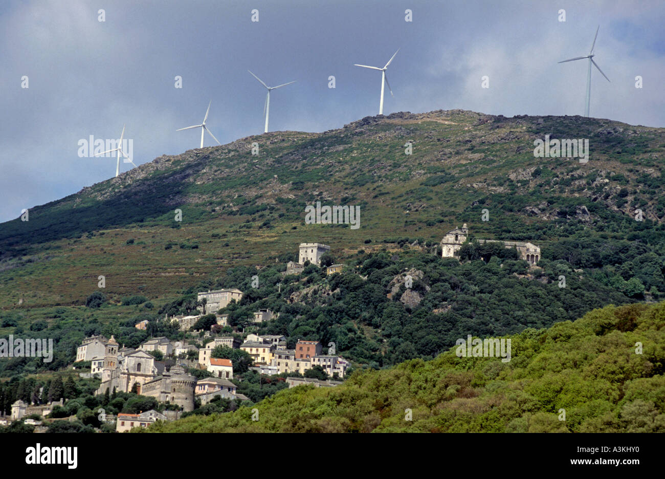 Wind turbines on a mountain top above Rogliano Village, Corsica Island, France. Stock Photo