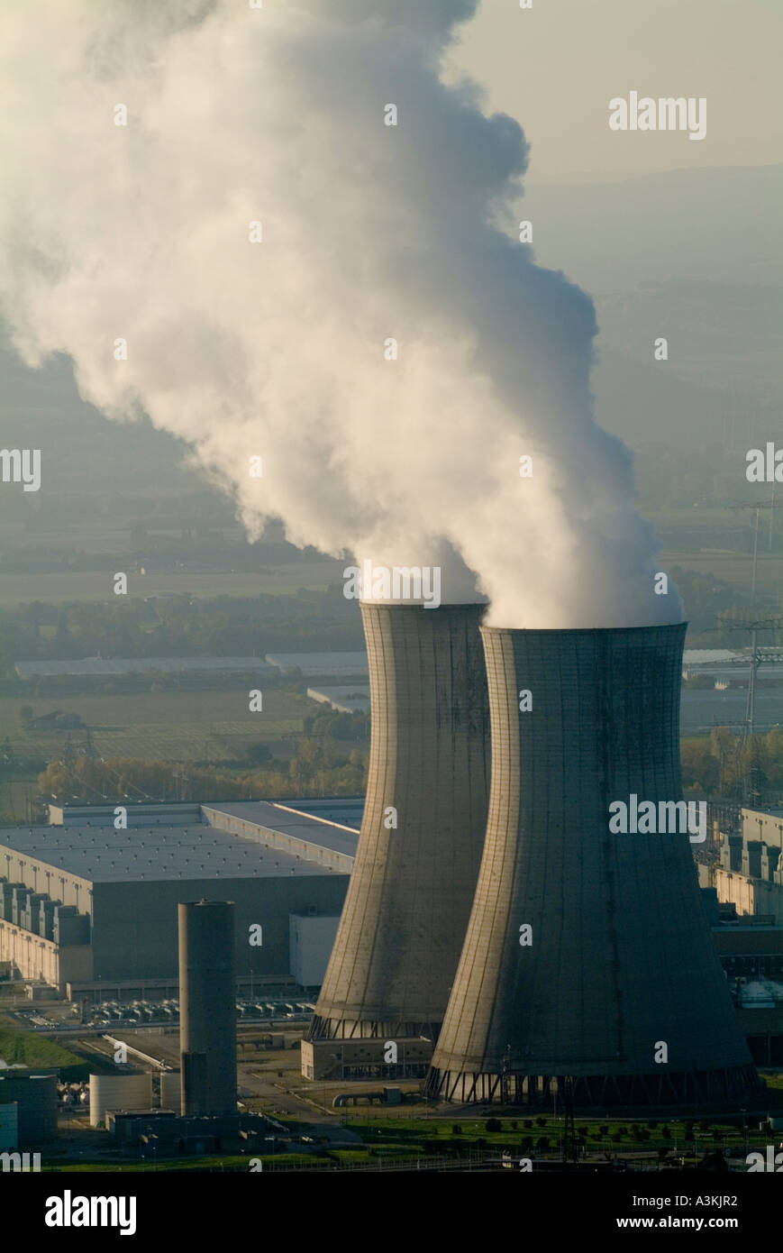 Smoke emitting from cooling towers at a nuclear power plant in the Rhone River Valley, Drome, France. Stock Photo