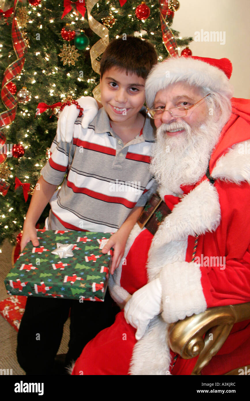 Miami Florida,office Christmas party,Santa Claus,Hispanic Latin Latino  ethnic immigrant immigrants minority,boy boys lad lads male kid kids child  chil Stock Photo - Alamy