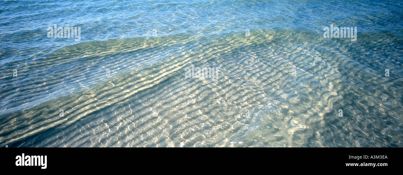 Crystal clear water ripples like molten glass beach side Bahia Honda State Park Bahia Honda Key Florida Stock Photo