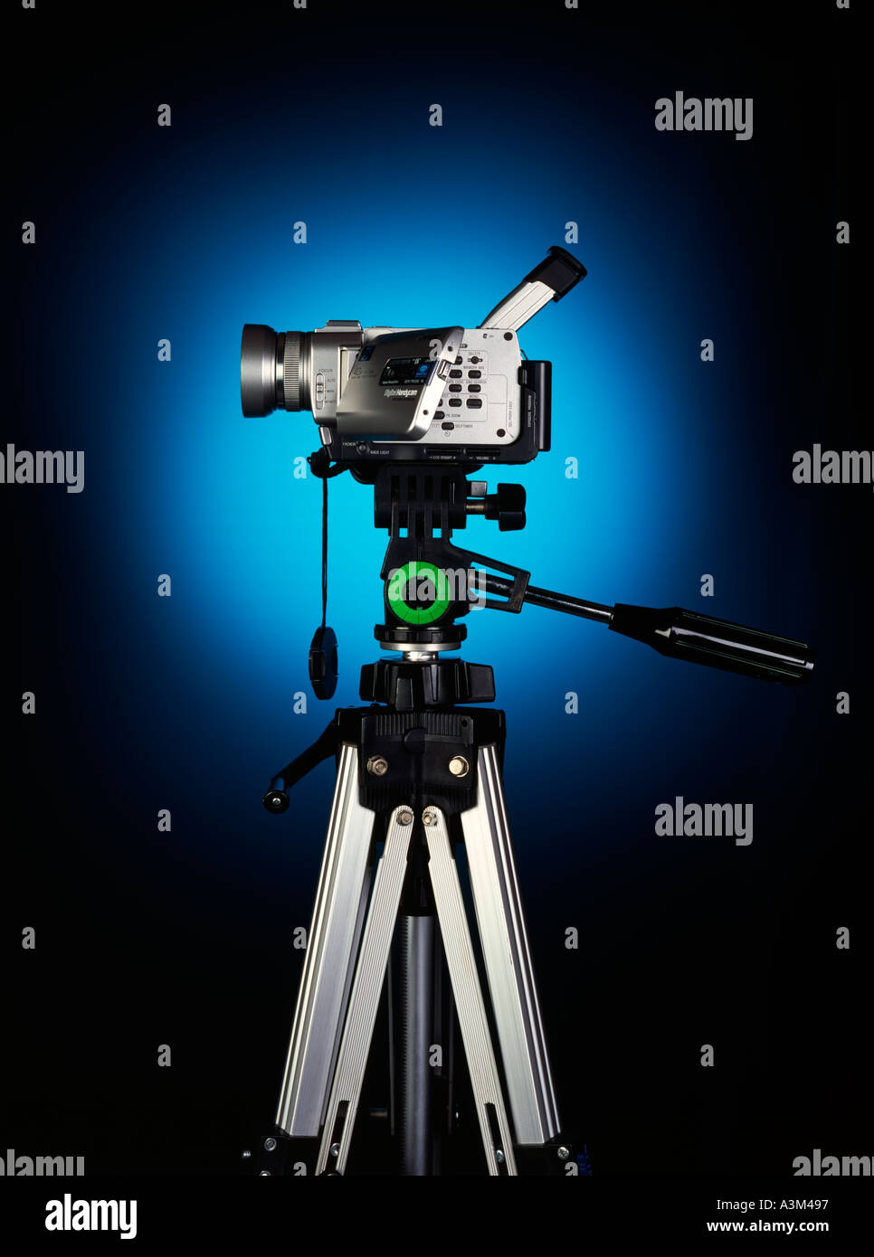 video camera on a tripod witha blue glow behind Stock Photo