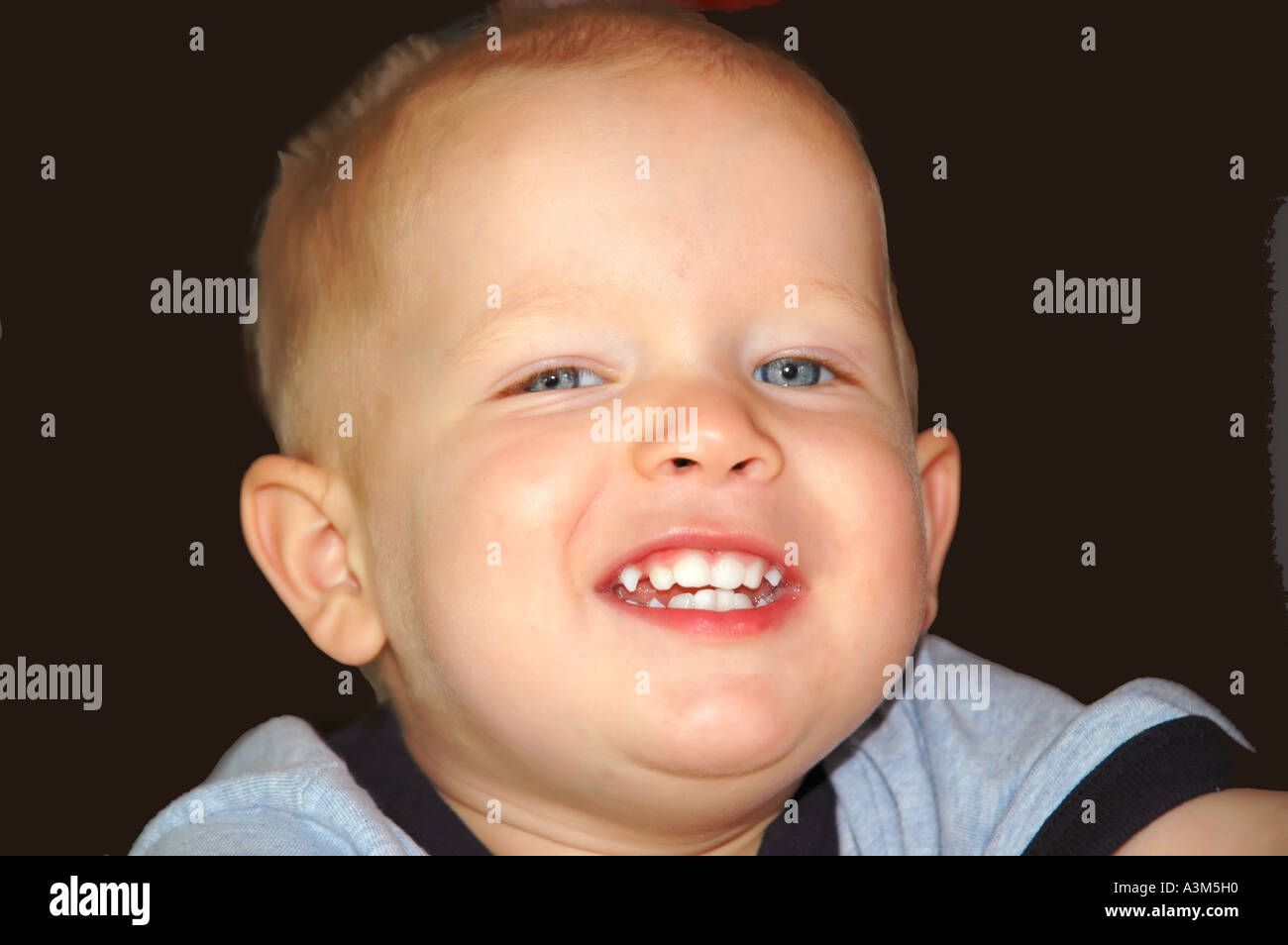 Portrait of a young boy with a toothy smile Stock Photo - Alamy