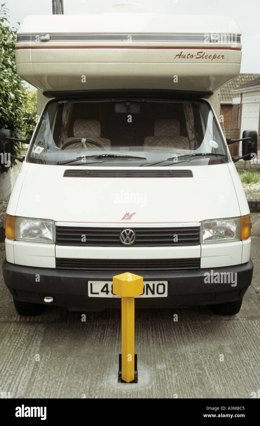 Key operated removable heavy steel security bollard concreted into domestic driveway help reduce theft of VW Auto Sleepers motorhome Essex England UK Stock Photo